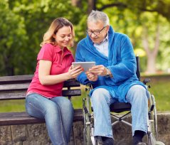 portrait of an elder and a caregiver having fun