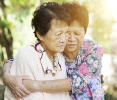 elderly women hugging