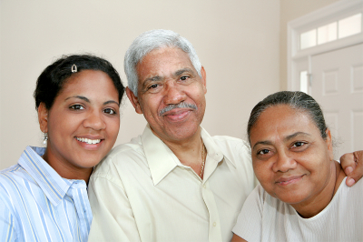 caregiver and senior couple smiling